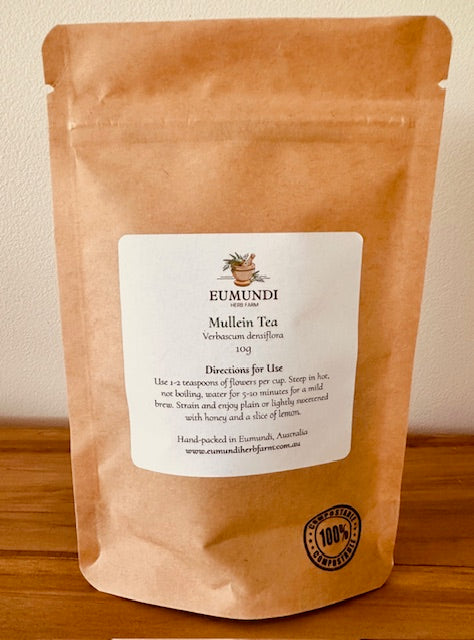 Brown package of Eumundi Mullein Tea with a label on a wooden surface.