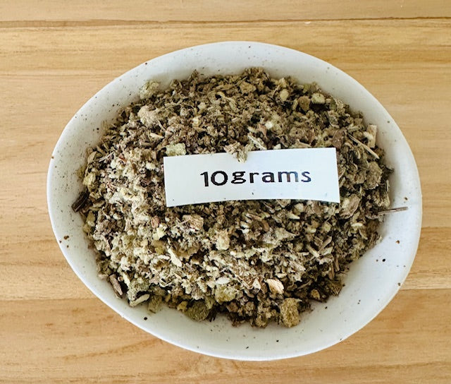 White bowl with mullein tea on a wooden surface