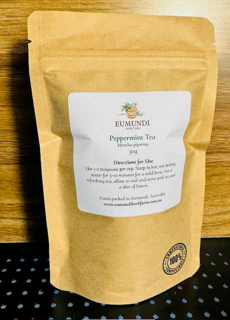 Eumundi Herb Farm peppermint tea package on a wooden surface