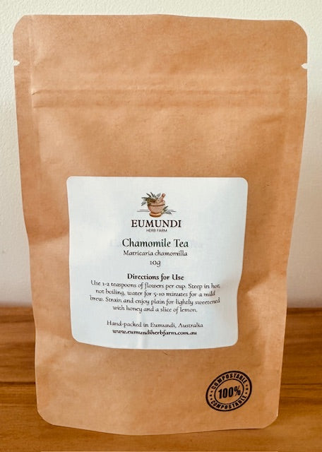 Eumundi herb Farm Chamomile Tea package on a wooden surface with a plain background