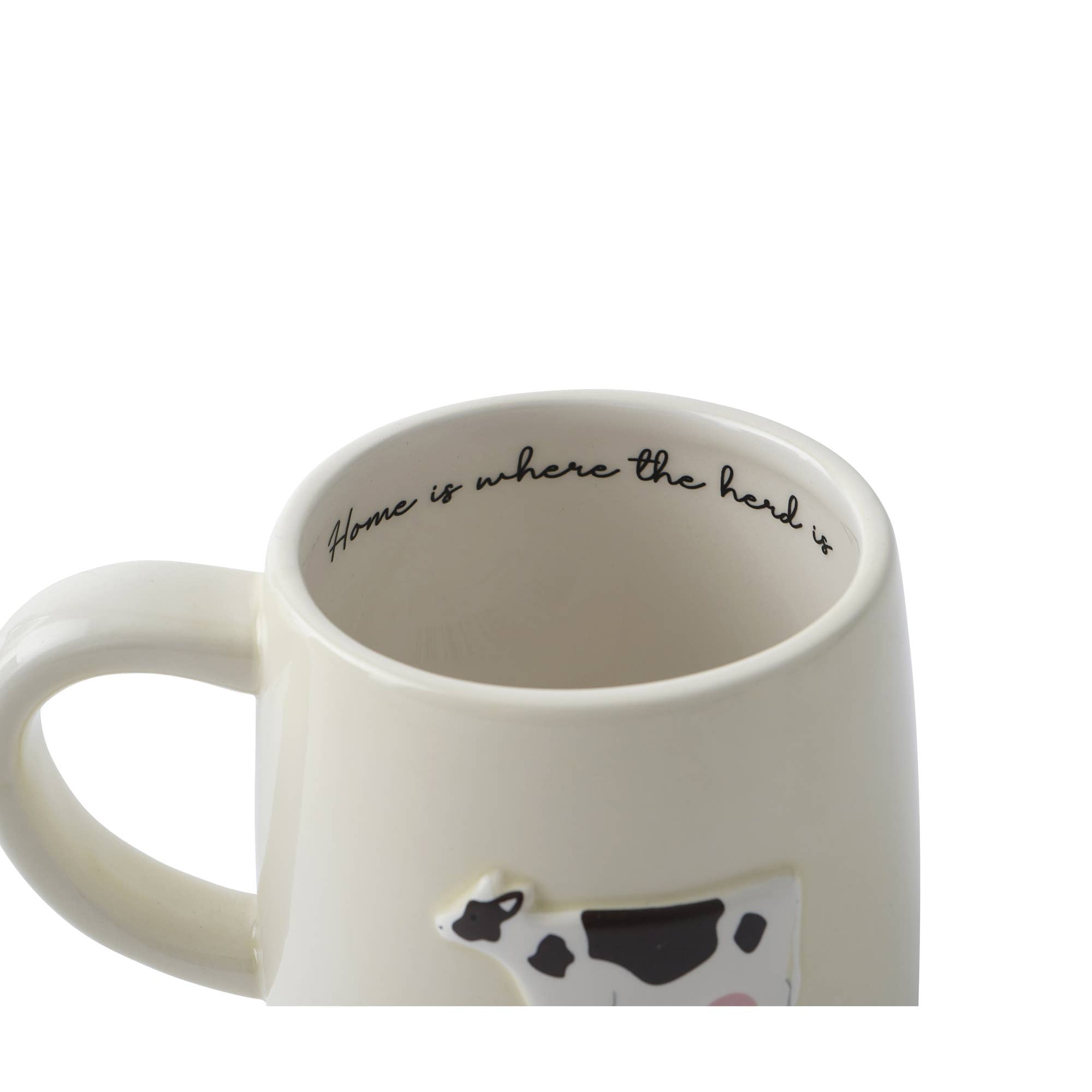 White mug with cow design and 'Home is where the herd is' text on a white background