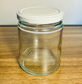 Clear glass jar with a white lid on a wooden surface