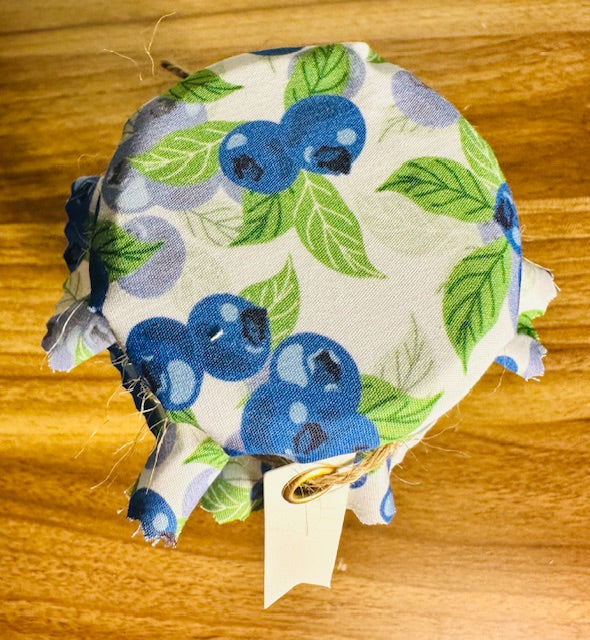 Fabric patch with blueberry pattern on a wooden surface