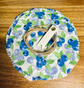 Round fabric cover with blueberry design on a wooden surface