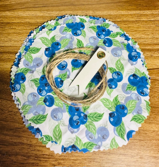 Round fabric cover with blueberry design on a wooden surface
