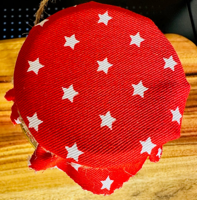 Red fabric with white star pattern on a wooden surface