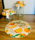 Decorative jars with orange-themed fabric covers on a wooden surface.