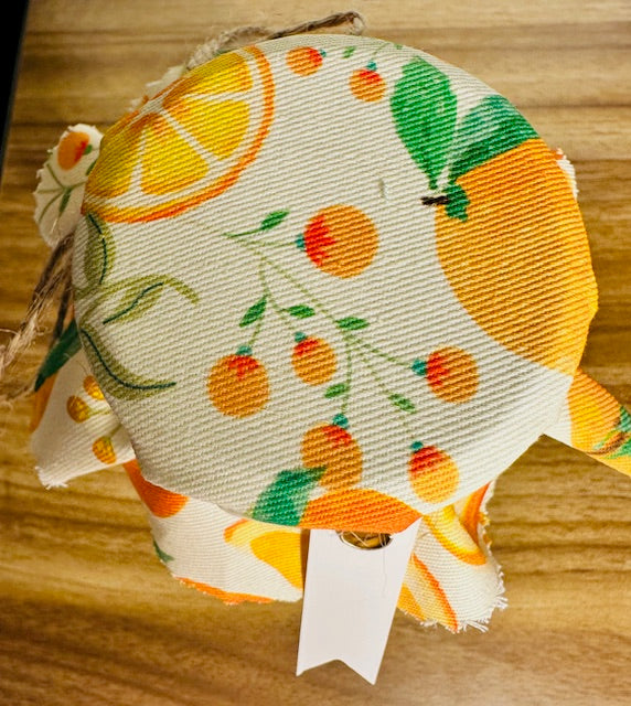 Fabric with orange and lemon pattern on a wooden surface