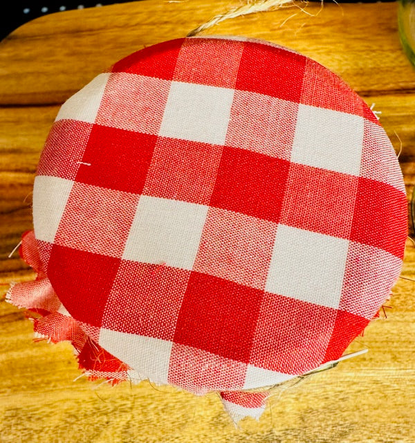 Red and white checkered fabric cover  on a wooden surface