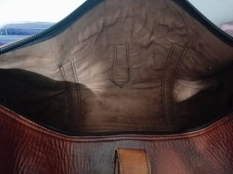 Close-up of a brown leather bag with visible stitching