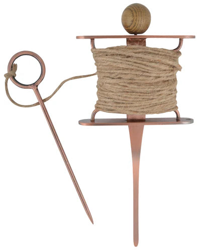 Copper yarn swift with a ball of yarn on a white background