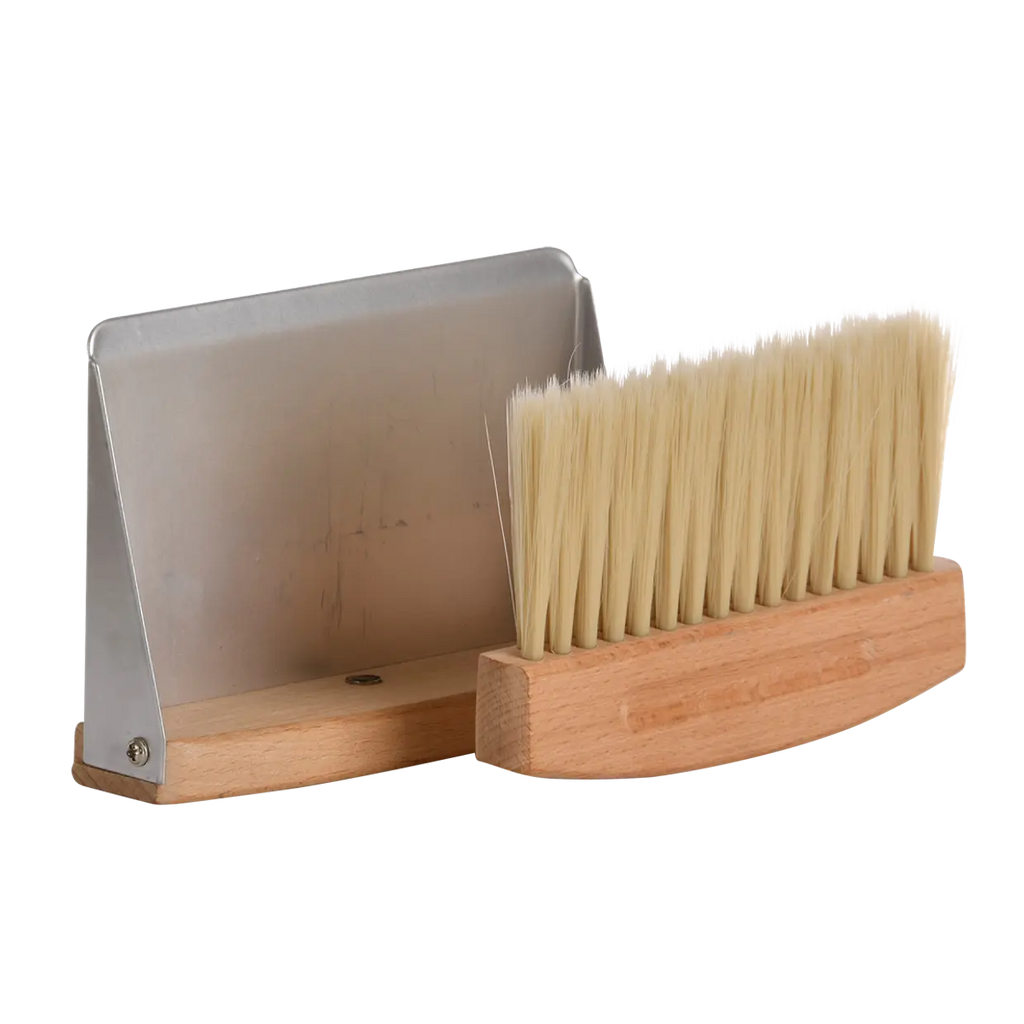 Wooden brush with metal handle on a white background