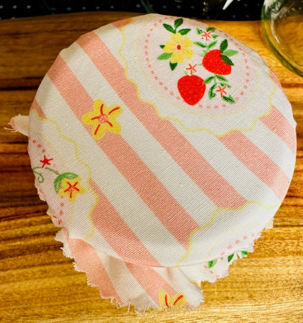 Striped fabric with floral embroidery on a wooden surface