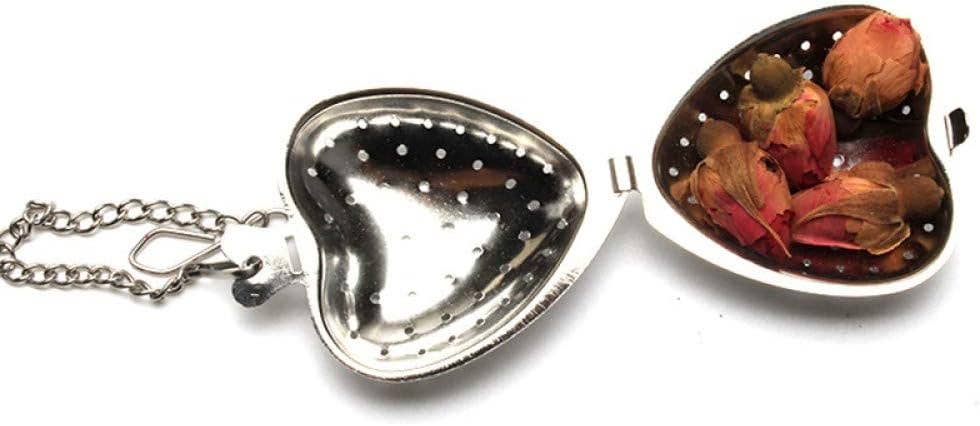 Heart-shaped metal tea infuser with dried flowers on a white background
